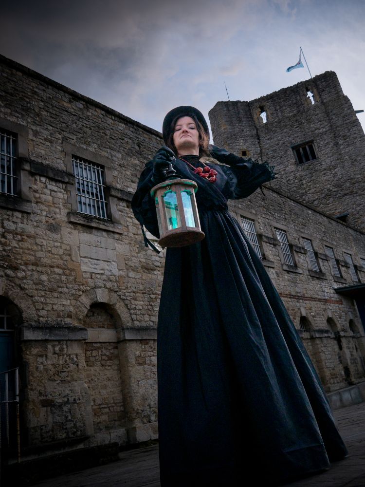 woman dressed in black as guide for spectre ghost tours at oxford castle and prison