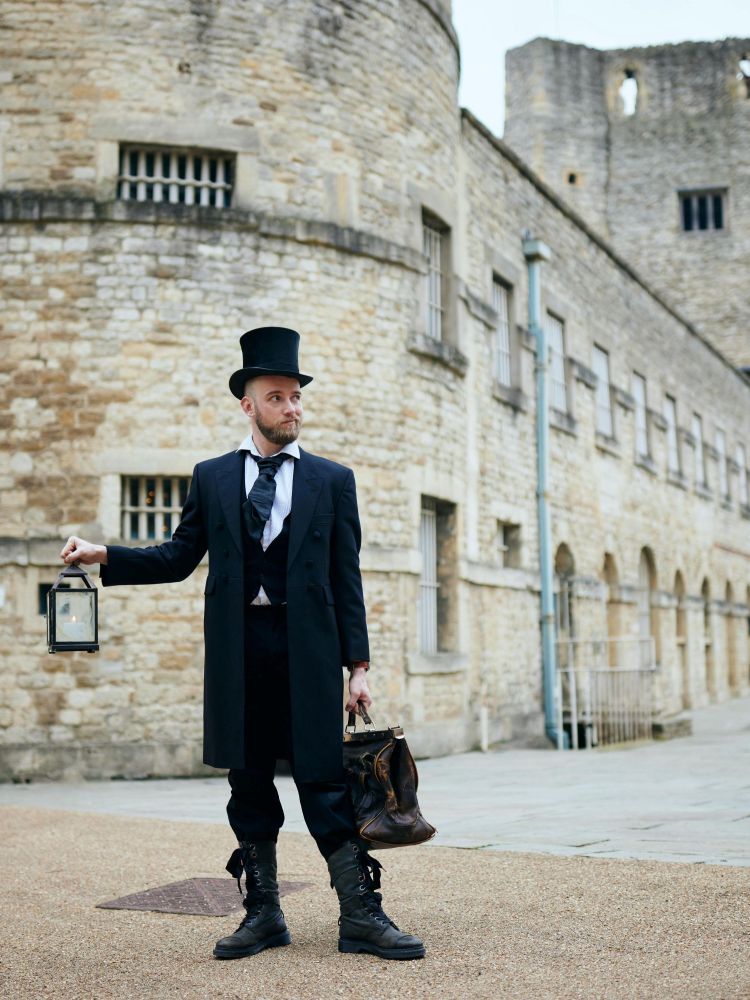 man dressed in black as guide for spectre ghost tours at oxford castle and prison