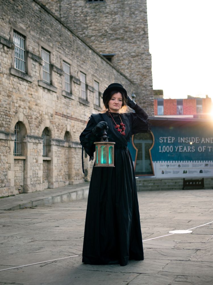 woman dressed in black as guide for spectre ghost tours at oxford castle and prison