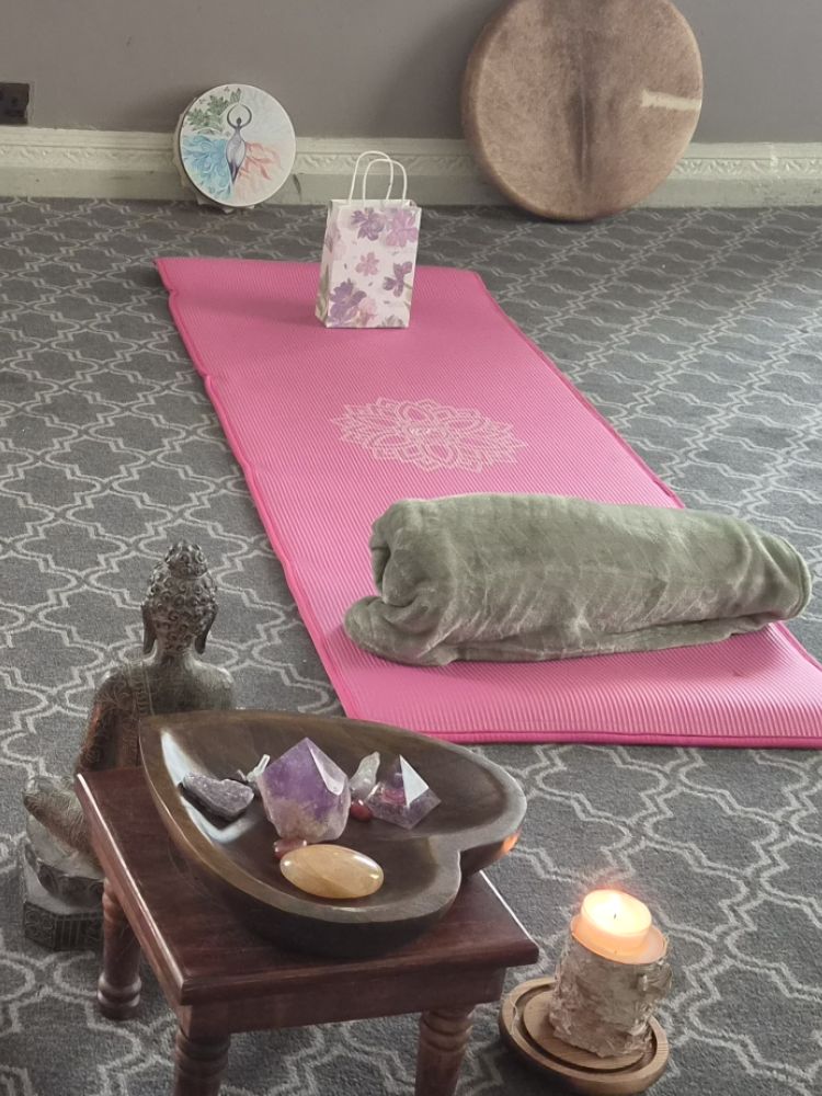 room prepared for meditation with mats and candles on floor on wellness retreat day