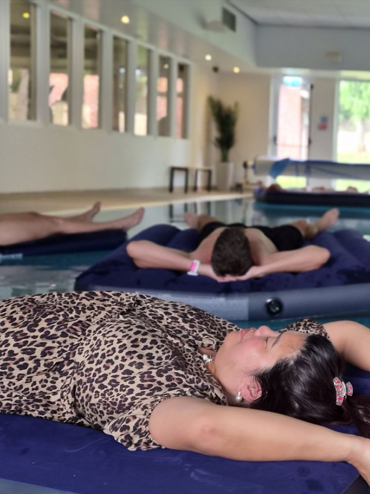 ladies floating on pool for water sound bath on wellness retreat day