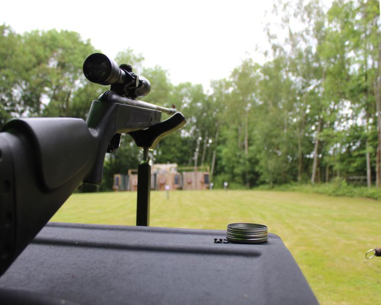 rifle set up with target in distance for pistol and rifle shooting experience