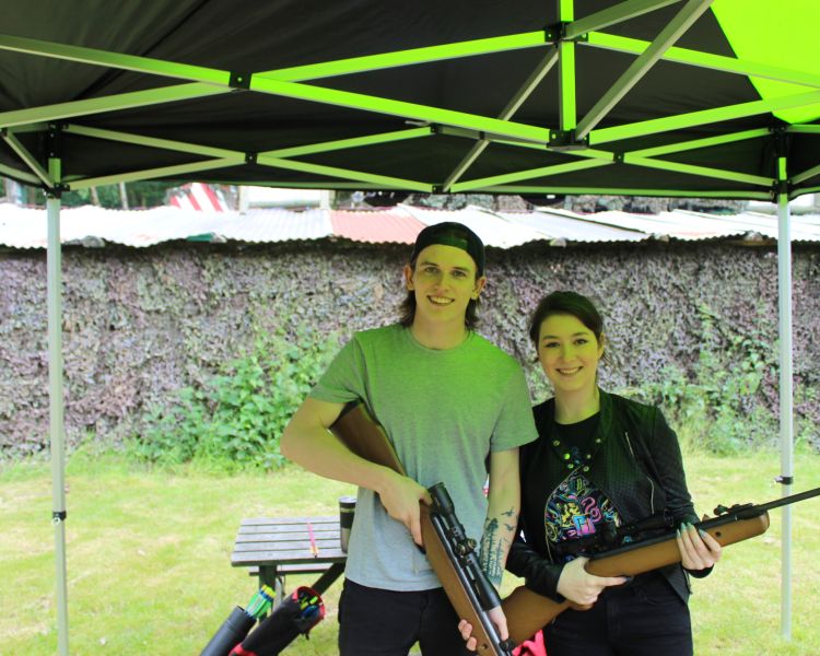 young man and woman holding rifles on pistol and rifle shooting experience