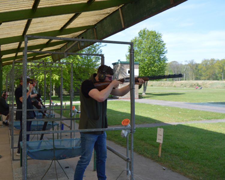 A man aiming at the clay pigeon shooting range