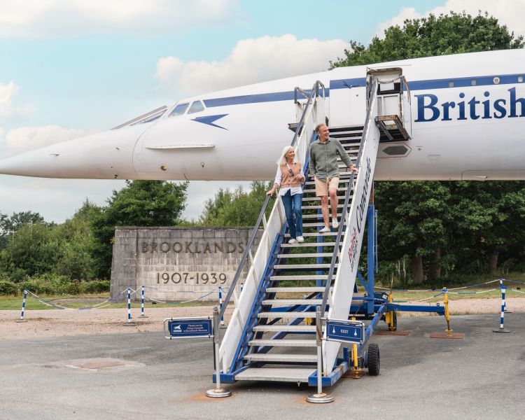 couple walking down the steps of concorde at brooklands museum