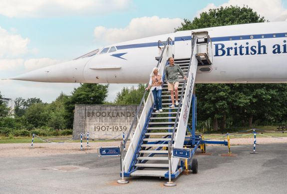couple walking down the steps of concorde at brooklands museum