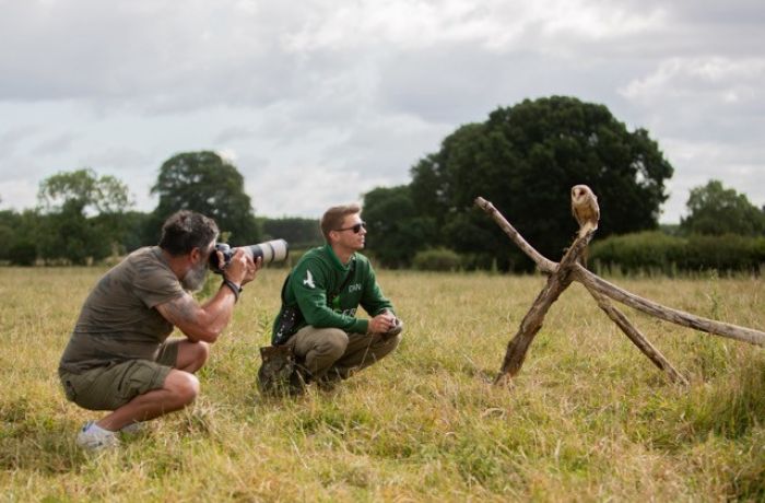 Man taking photo of bird of prey on photography experience