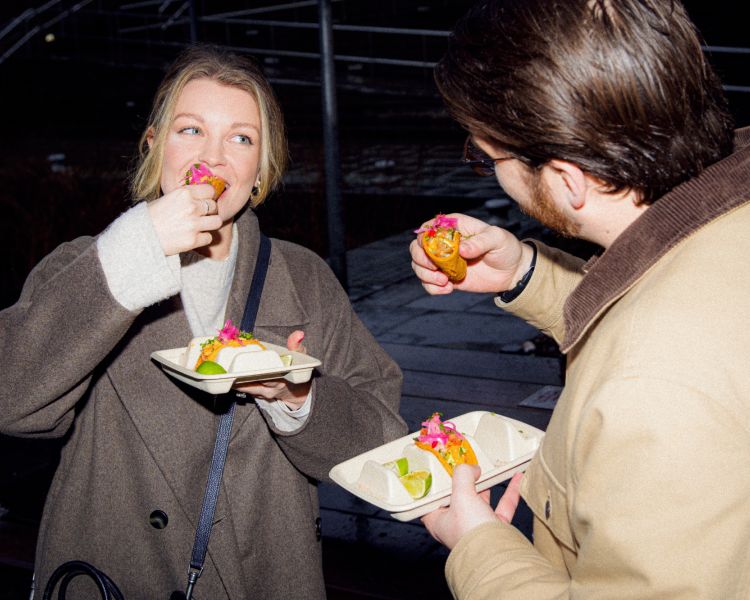 Man and woman eating tacos on food treasure hunt in manchester