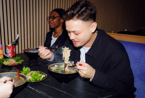 Friends eating ramen on a food treasure hunt in manchester