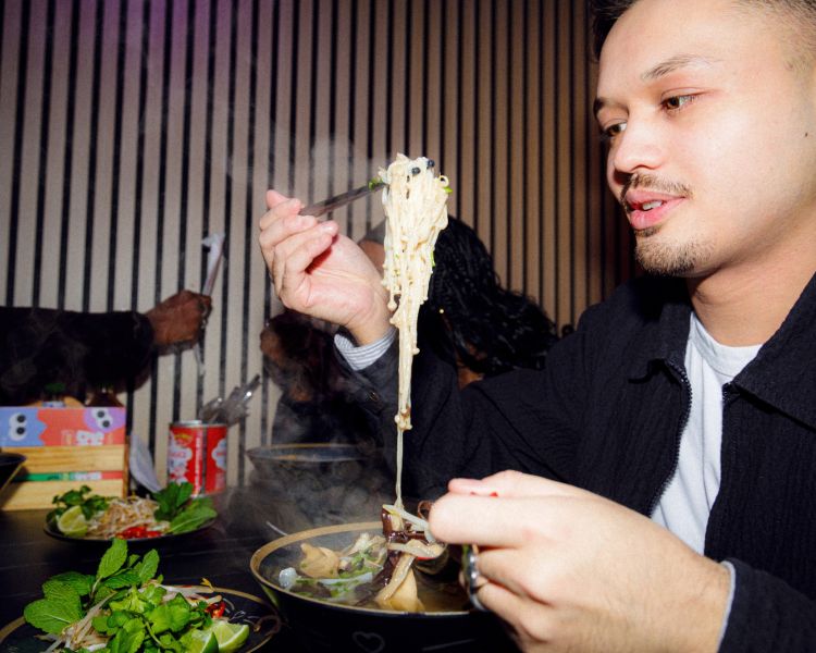 Man eating noodle dish on a food treasure hunt in manchester