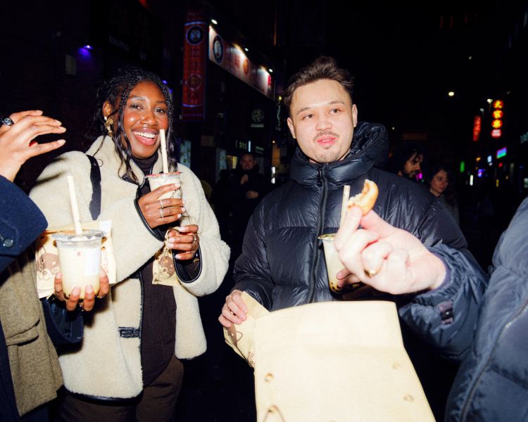 Friends with bubble tea and cakes on a food treasure hunt in manchester