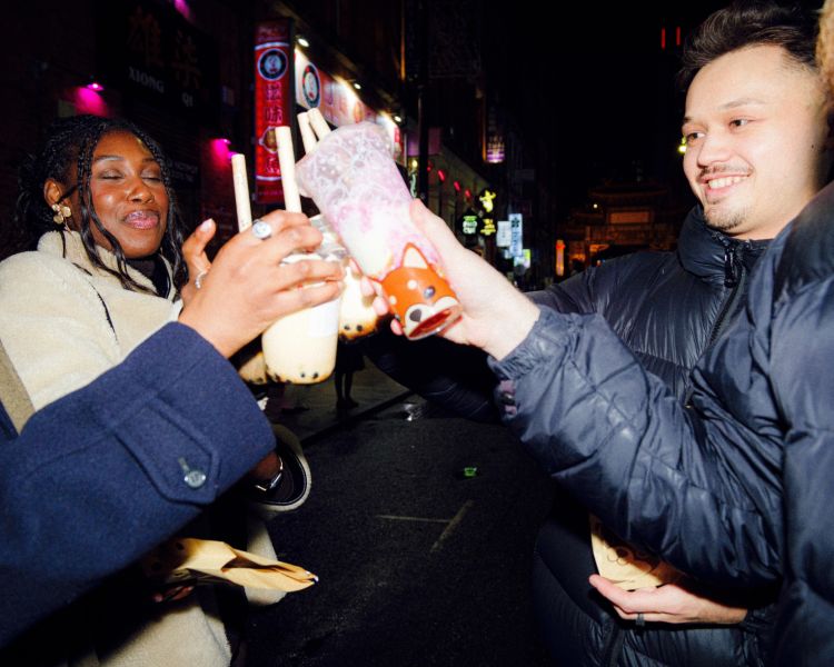 Friends with bubble tea takeout on a food treasure hunt in manchester