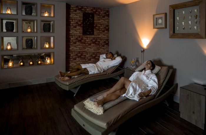 A couple lounging in spa robes