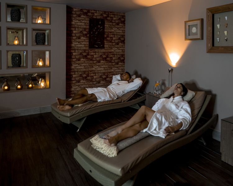 A couple lounging in spa robes