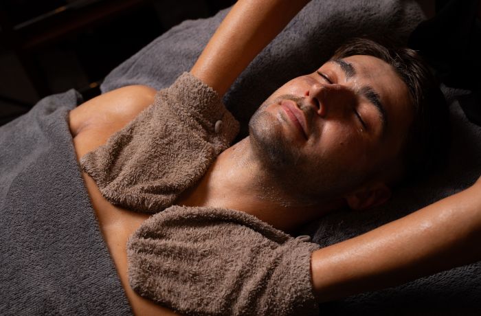A man getting a facial spa treatment and massage