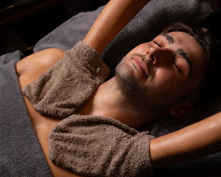 A man getting a facial spa treatment and massage