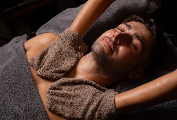 A man getting a facial spa treatment and massage