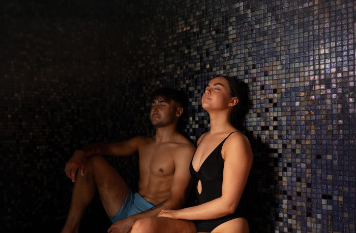 A man and woman in a sauna