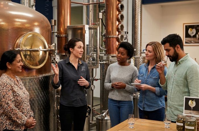 Group listening to guide on gin distillery tour