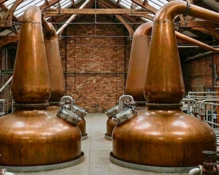 Copper stills seen on whisky distillery tour