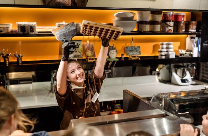 Chocolatier making chocolate rain for tour group