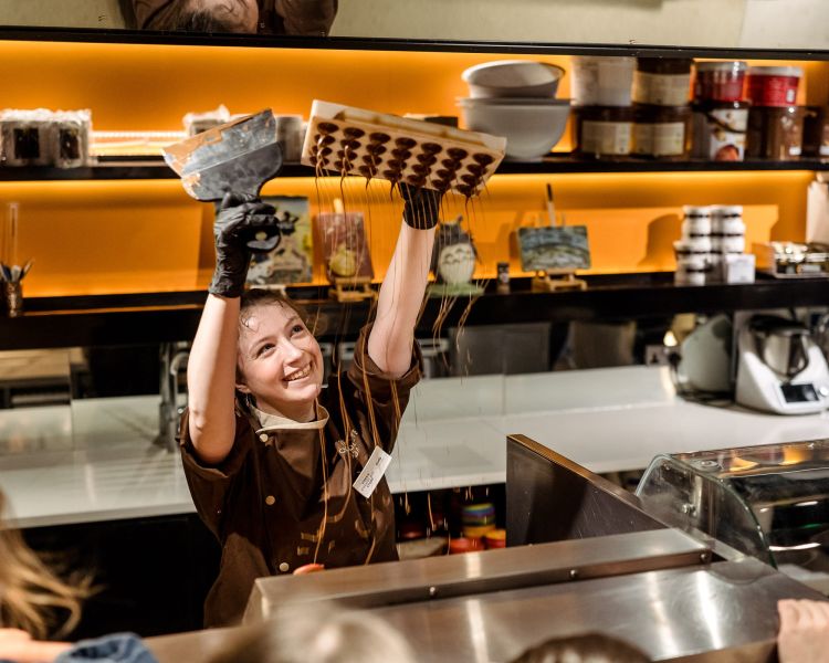 Chocolatier making chocolate rain for tour group