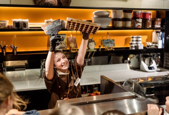 Chocolatier making chocolate rain for tour group