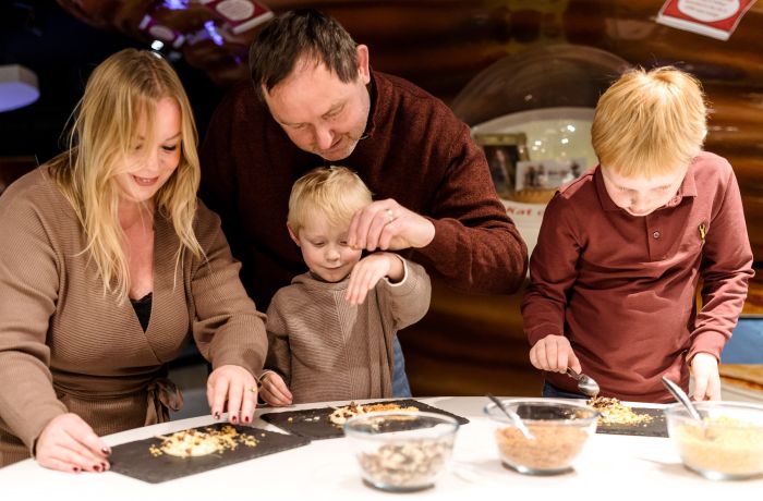 Family making chocolate lollies at york chocolate story