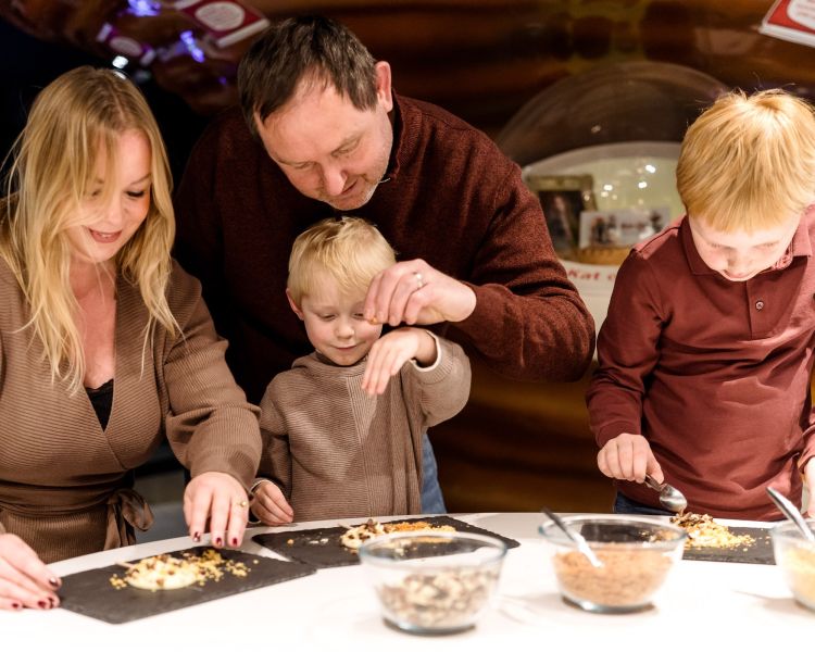 Family making chocolate lollies at york chocolate story