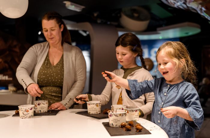 Family rolling truffles at york chocolate story