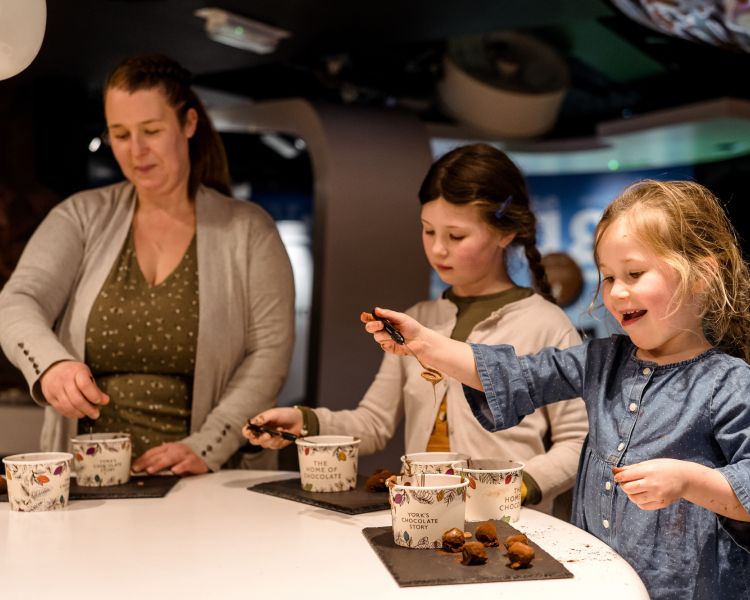 Family rolling truffles at york chocolate story