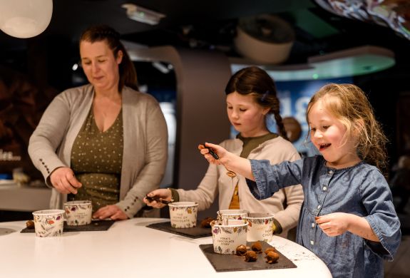 Family rolling truffles at york chocolate story