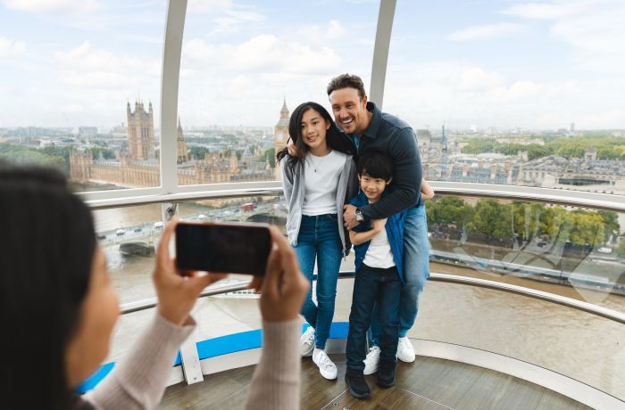 mum taking photo of dad and kids on the london eye