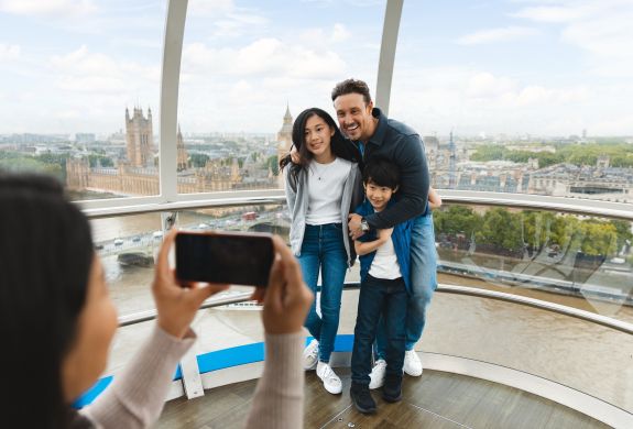 mum taking photo of dad and kids on the london eye