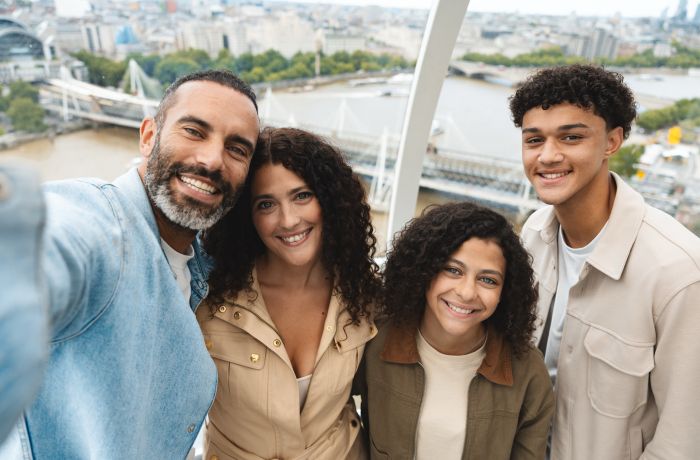 a family photo in a london eye pod overlooking london