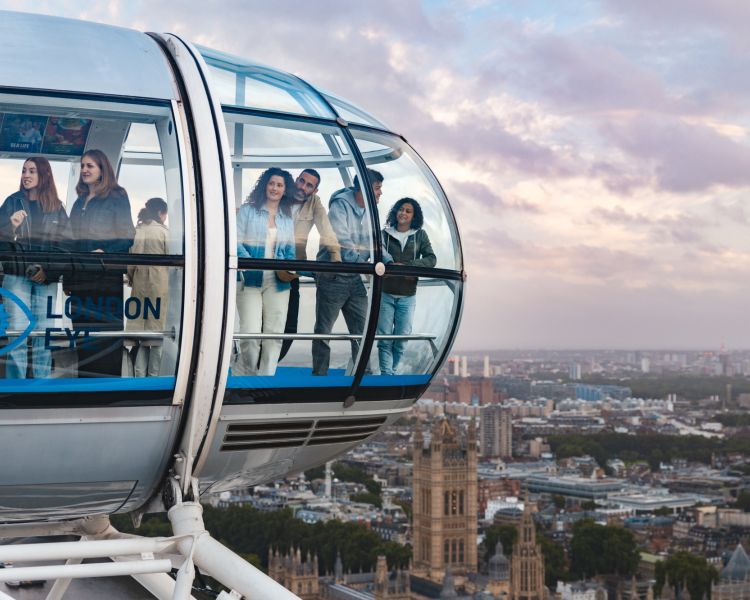 people looking out of london eye pod over london