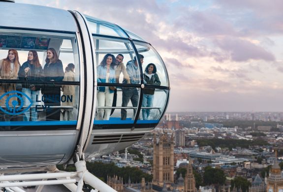 people looking out of london eye pod over london