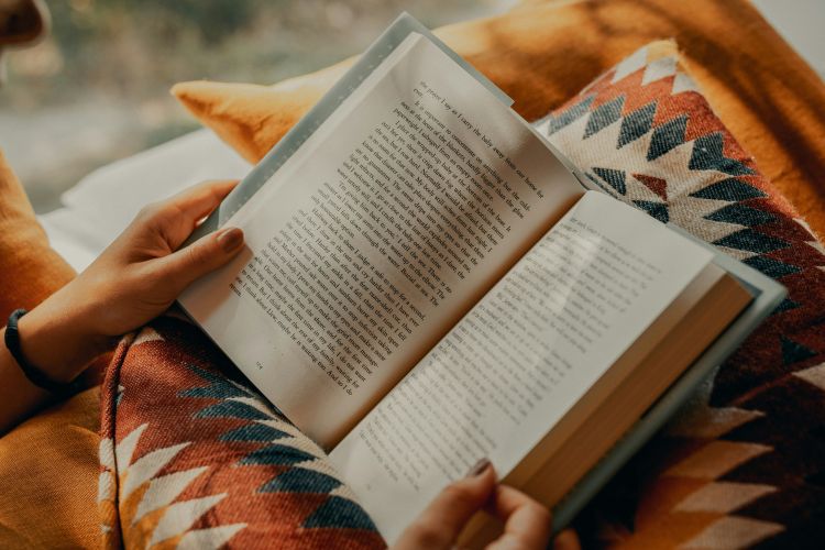 Stock image of book being read on cushion