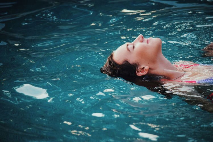 Stock image of woman on back in swimming pool