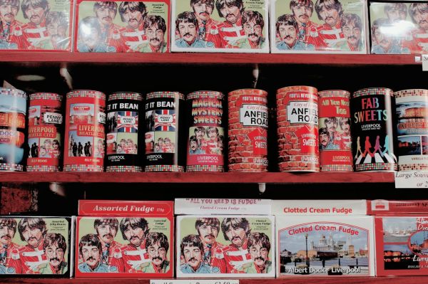 shelves with souvenir tins of sweets and boxes of fudge with the beatles images on