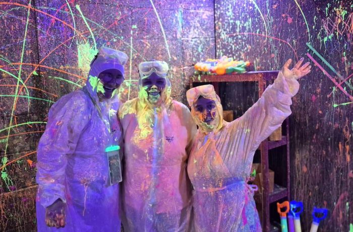 Three guests in the splatter paint room