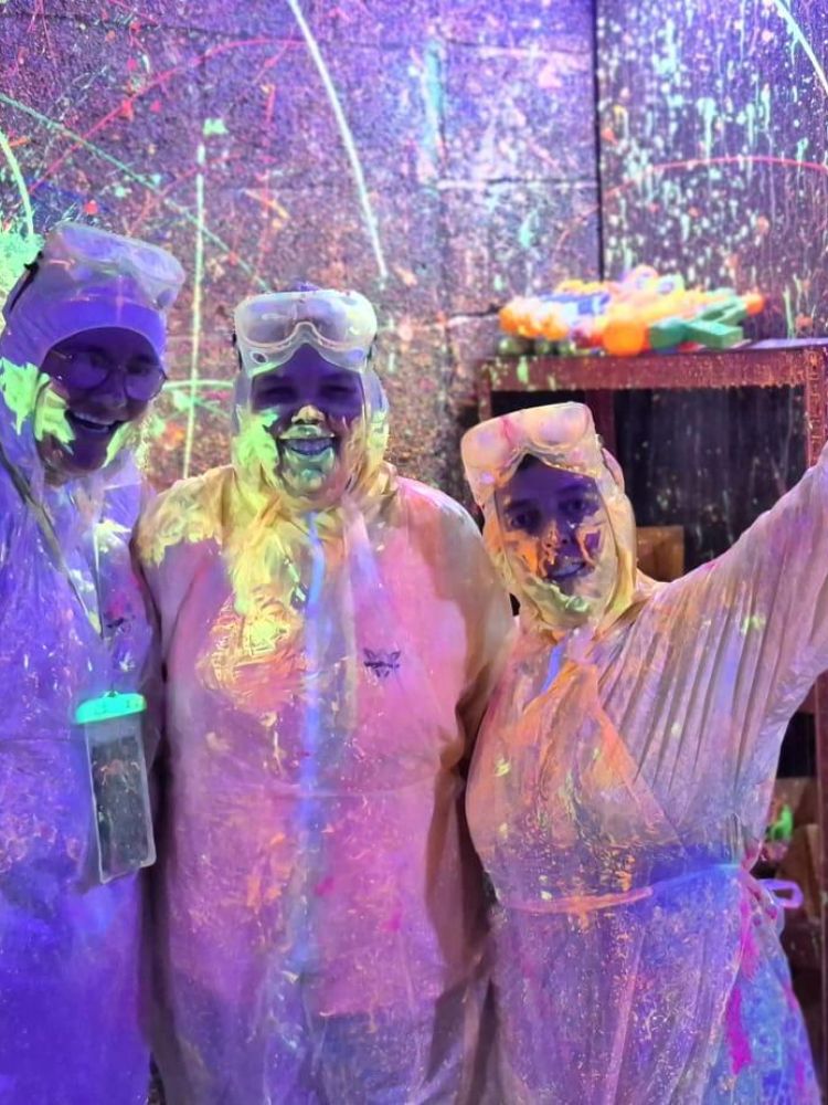 Three guests in the splatter paint room