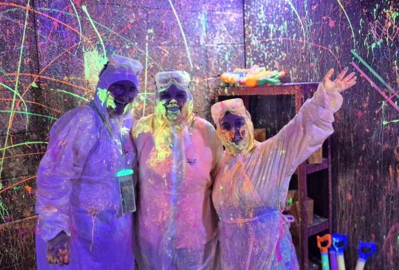 Three guests in the splatter paint room
