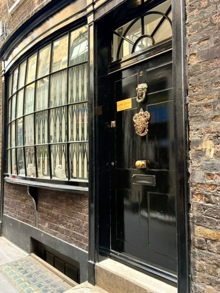 Black door with gold knocker seen on harry potter walking tour in london