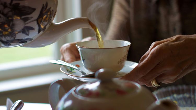 Stock image of tea being poured into a teacup