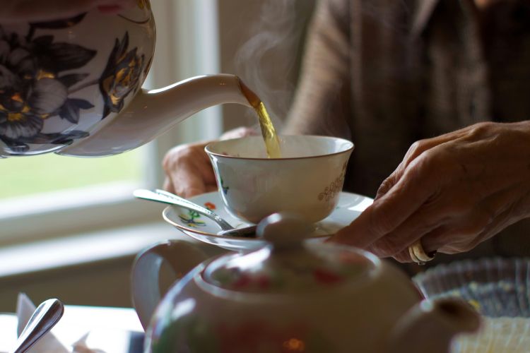 Stock image of tea being poured into a teacup