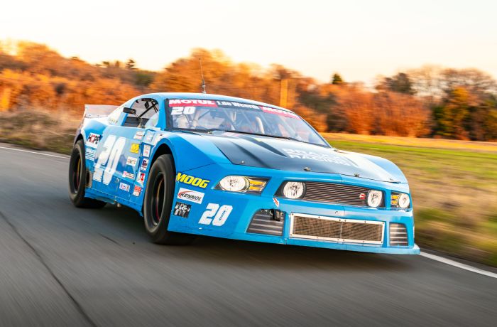 a mustang "late model nascar" on a race track at a gt race car driving experience