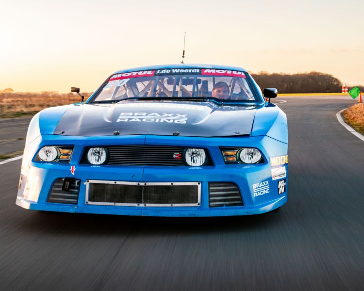 a mustang "late model nascar" on a race track at a gt race car driving experience