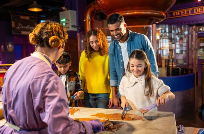 family having a go at chocolate tempering at cadbury world
