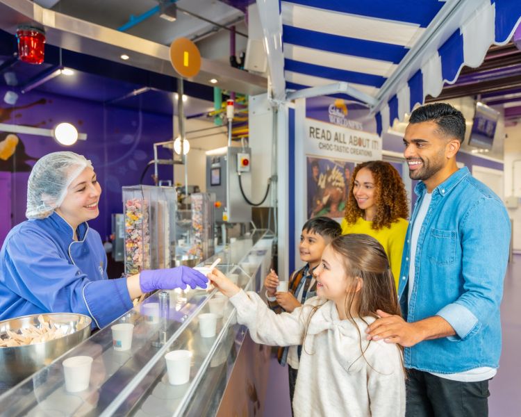 family at chocolate making stand at cadbury world